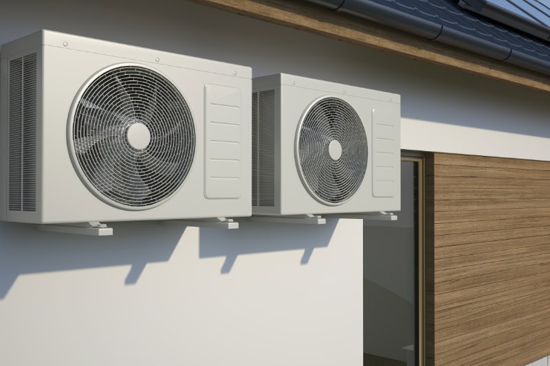 two air conditioning units outside of a home.