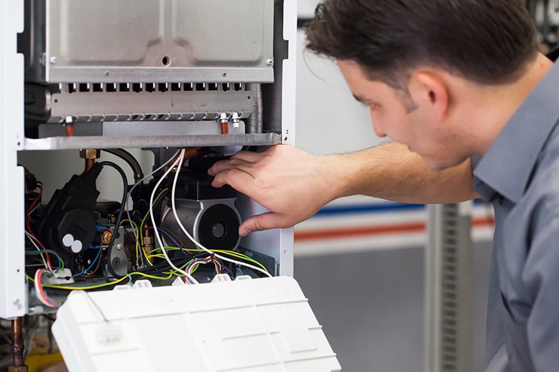 A service tech workign on a HVAC unit.