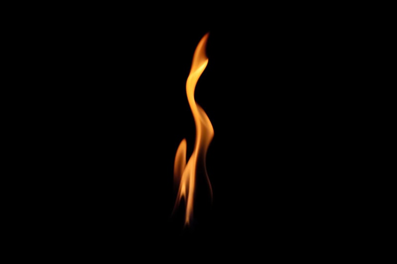 10 Ways to Lower Your Heating Bill This Winter. Photo of a flame with a black background.