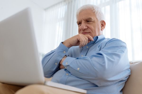 A man ponders while looking at a laptop. What’s That Sound Coming From My Furnace?