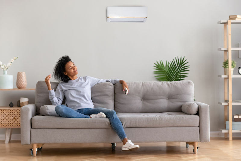 Happy Woman Sitting on Her Couch